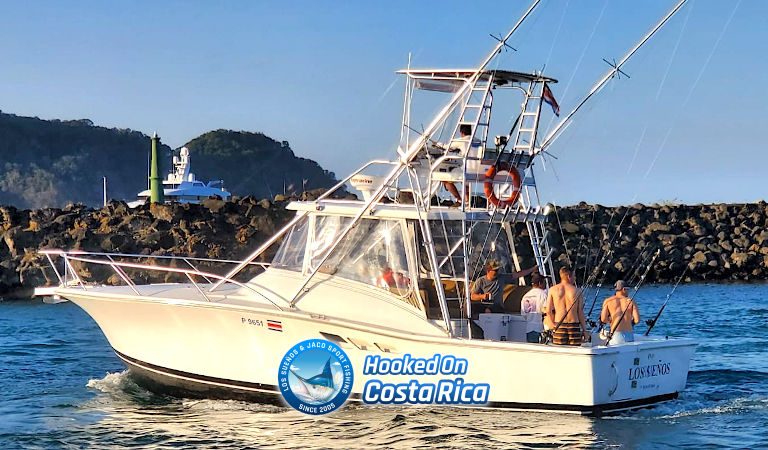 36 foot Luhrs Express sportfisher with tuna tower passing the marina breakwater